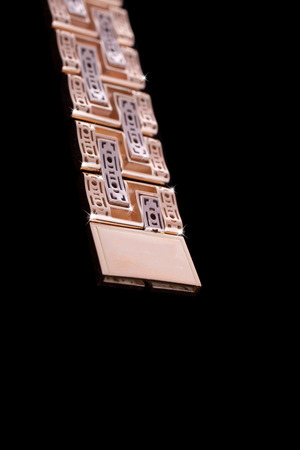 Precious yellow gold chain male on black isolated background. Good material for design jewelery.の写真素材