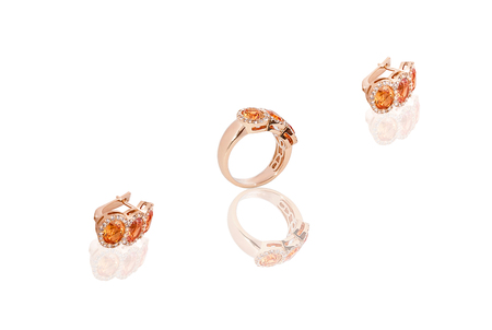 Yellow gold precious earrings ring with diamonds on white isolated background. Good material for design jewelery.の写真素材