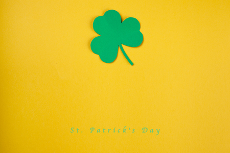 Paper green leaf of clover on Yellow background. Happy St. Patrick's Day good concept card.の写真素材