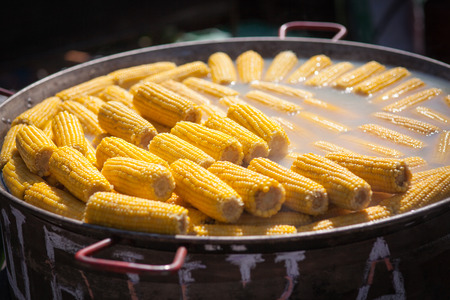 Process of preparation of boiled corn in a cauldron on a fire, a tasty dish.