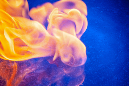 Incredible pattern created by oil, pollution of nature, the background as oil makes a wild space on water. Petals of a burning flame, fancy forms.の写真素材