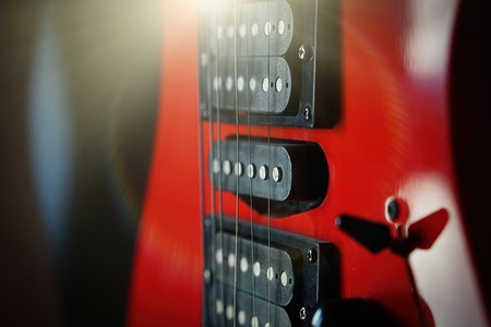 Close-up electric guitar sunbeams musical card. Musical string instrument, a good idea for music.の写真素材