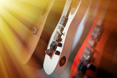 Close-up electric guitar sunbeams musical card. Musical string instrument, a good idea for music.の写真素材