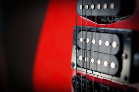 Close-up electric guitar sunbeams musical card. Musical string instrument, a good idea for music.
