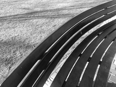 Pattern of geometric shapes on a street bench of wood on the lawn black and whiteの写真素材