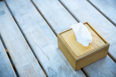 Soft focus, napkin box a restaurant accessory on a wooden old table of bar.の写真素材