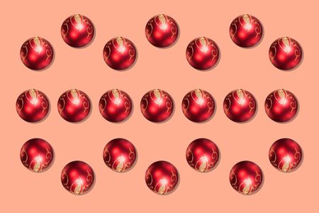 Red Christmas baubles decoration on pastel background. New Year party background. Minimal style. Flat lay.の写真素材