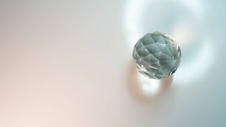 Large crystal on a white  with light refraction abstractionの写真素材
