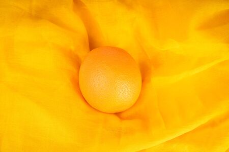 Natural Fruit Orange on orange fabric view from the top. A fruit rich in vitamins for healthy nutrition.の写真素材