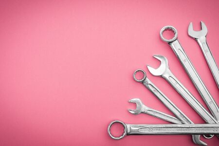Set of wrenches a professional tool for repair and assembly of structures, pattern concept on a pinkの写真素材