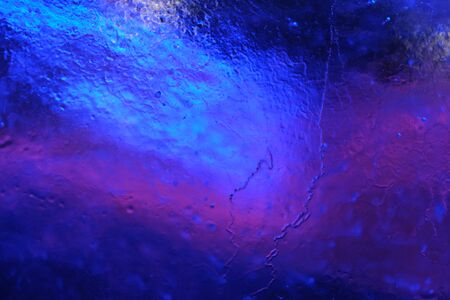 Abstract background of illuminated glossy transparent colored ice textureの写真素材