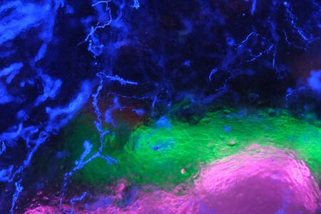 Abstract background of illuminated glossy transparent colored cracked ice textureの写真素材