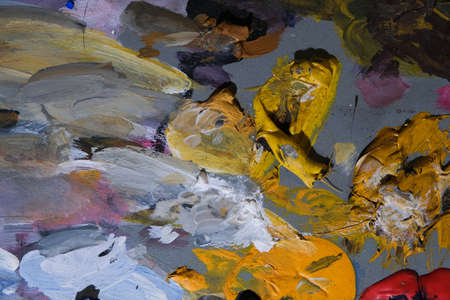 Background of an artist's palette with mixed dried acrylic paints. An abstract artwork.の写真素材