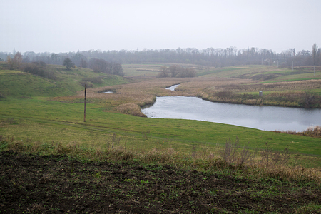 A small river in a village that flows into a large riverの写真素材