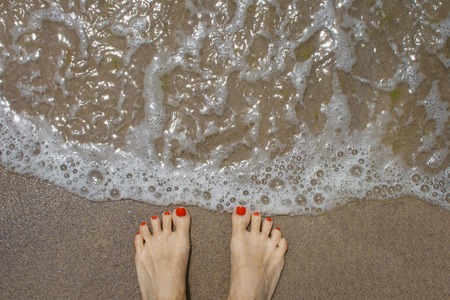 Female feet on the beachの写真素材