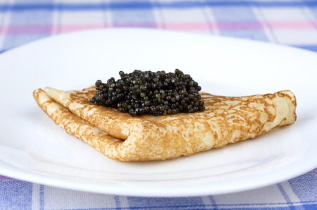 Pancakes with black caviar on plateの写真素材