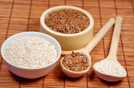 Flax seeds and oat bran on bamboo napkinの写真素材