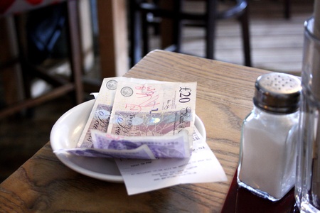 Restaurant bill paid with UK poundの写真素材