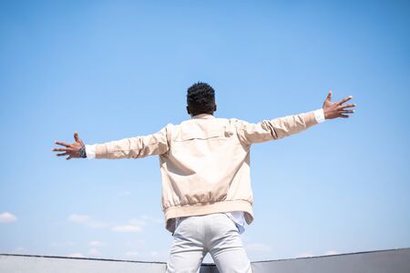 Handsome black young man in a jacket and white shirt on the street. Businessmanの写真素材