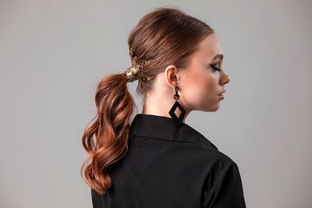 Beautiful young woman with make-up in a black shirt. Sparklesの写真素材