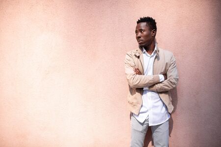 Handsome black young man in a jacket and white shirt on the street. Businessmanの写真素材