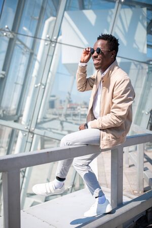 Handsome black young man in a jacket and white shirt on the street. Businessmanの写真素材