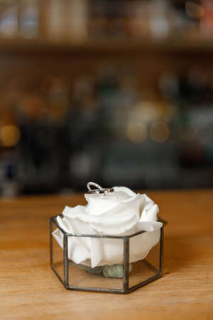 wedding rings with flowers before the wedding ceremony