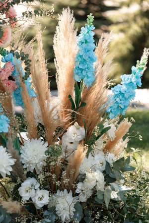 Details. Wedding ceremony in the open air of fresh flowers. Gentle and beautiful wedding decor for newlyweds.の写真素材
