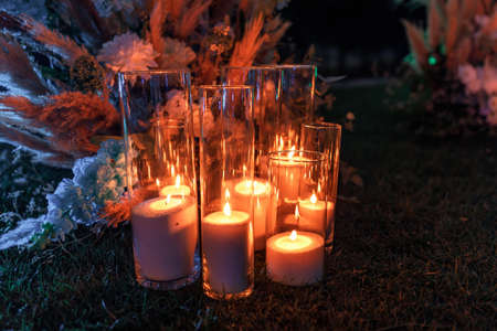 Details. Wedding ceremony in the open air of fresh flowers. Gentle and beautiful wedding decor for newlyweds at night.の写真素材