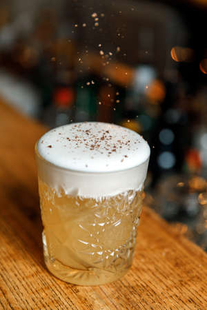 beautiful orange cocktail against the background of lights on the bar.の写真素材