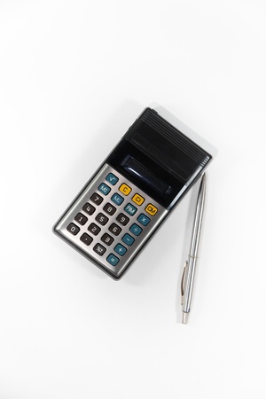 Old calculator and pen isolate on white backgroundの写真素材