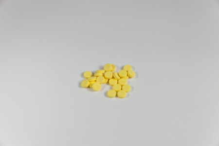 Yellow pills on white backgroundの写真素材