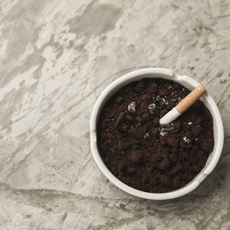 Burning cigarette in ashtray