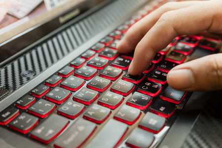 Close up of men hand during typing  the keyboard. Selective focus