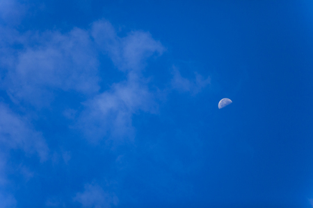 Blue sky with moon backgroundの写真素材