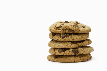 Stack of Chocolate chip cookies on wooden with white background.