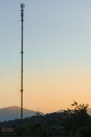 Telecommunication tower in countryside with sunset scene.の写真素材