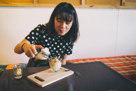 Asian girl enjoying with affogato ice cream in coffee shopの写真素材