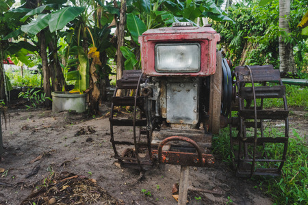 The hand tractor is parked on the garden in rural Thailand.の写真素材