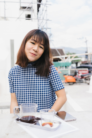 Young Asian beautiful woman in the coffee shop.の写真素材