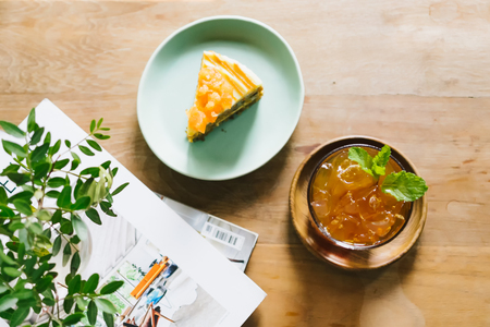 Top view of Iced lavender tea and Carrot cake on the wooden table.の写真素材