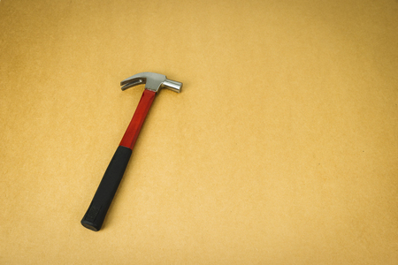 Hammer tool on brown retro background.の写真素材