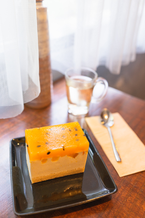 Passion fruit cake on the table in the cafe.の写真素材