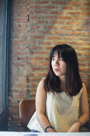 Asian woman in the cafe with sunlight.の写真素材