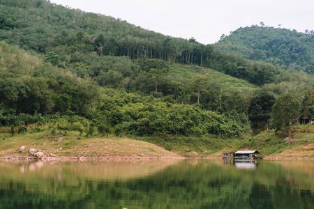 Landscape view of Bang Lang Reservoir with house raft in the lagoon and forest.の写真素材