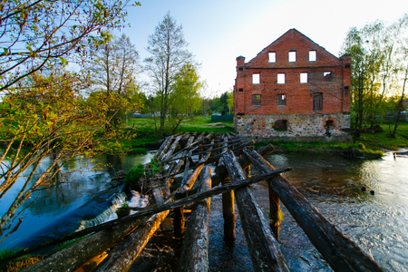 Old red brick construction near river in the countrysideの写真素材