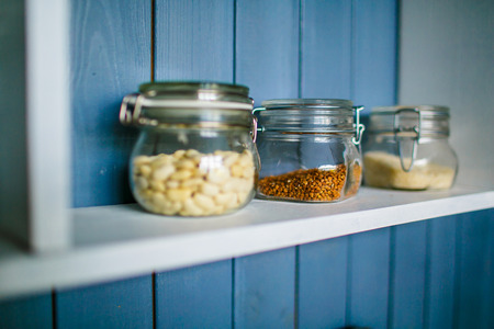 Small transparent jars for food on wooden shelfの写真素材
