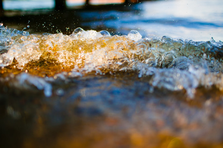 Soft wave reaching the pebbple beach macroの写真素材