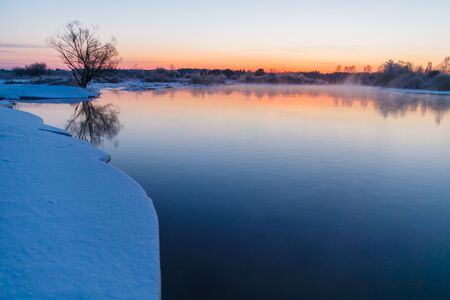 Sunrise starting over river in winter time. Rural landscapeの写真素材