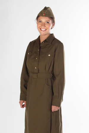 The young and beautiful girl in a military dress and a field capの写真素材